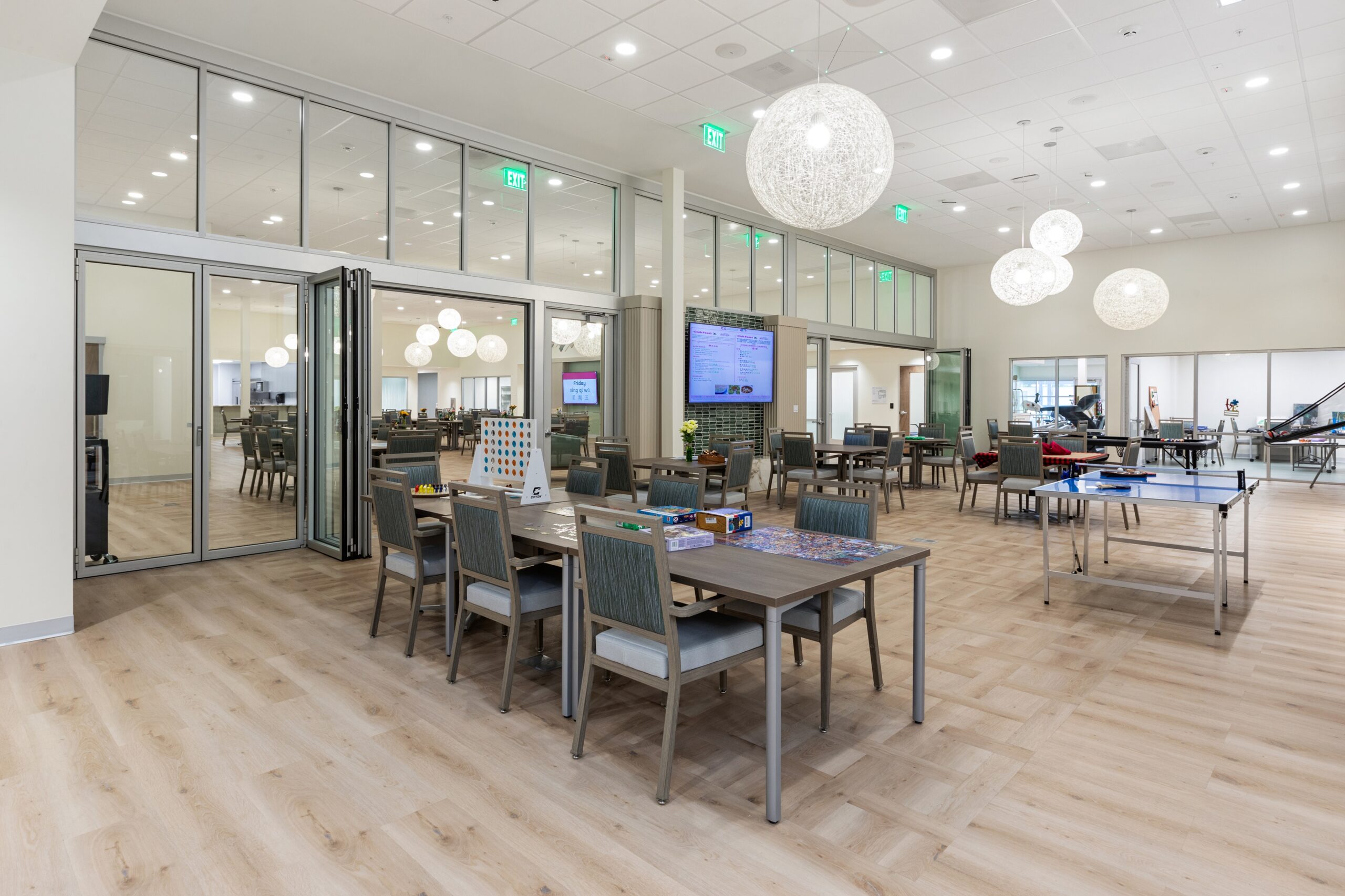 Modern, well-lit dining area with multiple tables and chairs.