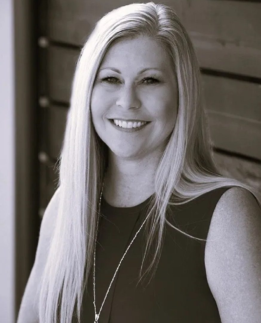 Smiling woman with long hair, black-and-white.